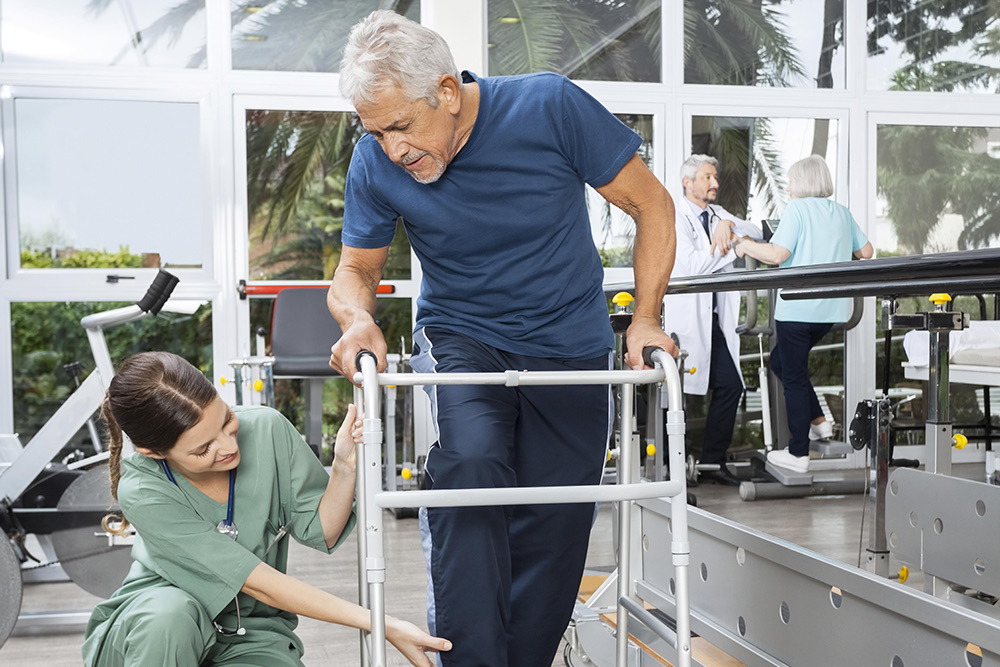 An Advinia Care caregiver walking with a resident